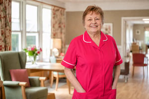 Senior Aged Care Staff Smiling at Camera in Pink